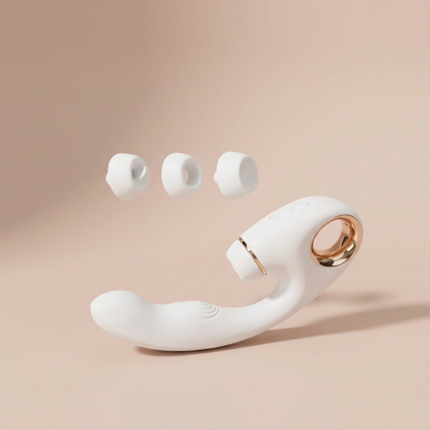 Close-up of the interchangeable suction heads for the white massager, showing options for different sensations.