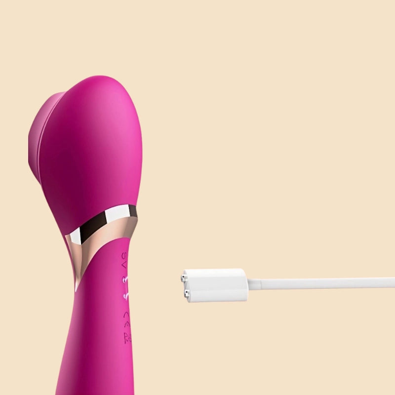A side-view image of a burgundy red dual-action adult toy, shown alongside its magnetic charging cable. The close-up clearly displays the convenient, secure magnetic charging port, emphasizing the product's advanced, hassle-free power solution designed for both safety and ease of use.