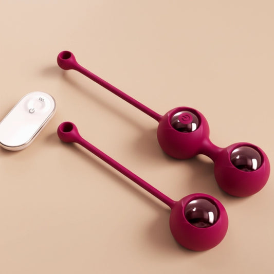 Top-down flat lay view of a complete pelvic floor exercise kit: wine-red 2-in-1 Kegel Ball, paired with a matching remote control, showcasing a versatile and discreet home workout solution