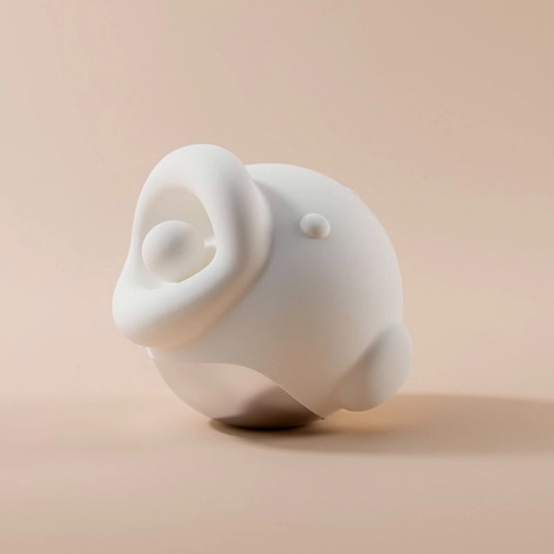 adorable fish-shaped vibrator made of soft silicone, featuring wide lips and 360° licking tongue, displayed on a pink-lilac gradient background