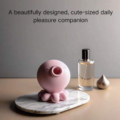 Pink octopus-shaped device on a marble coaster with a bottle of perfume in the background.