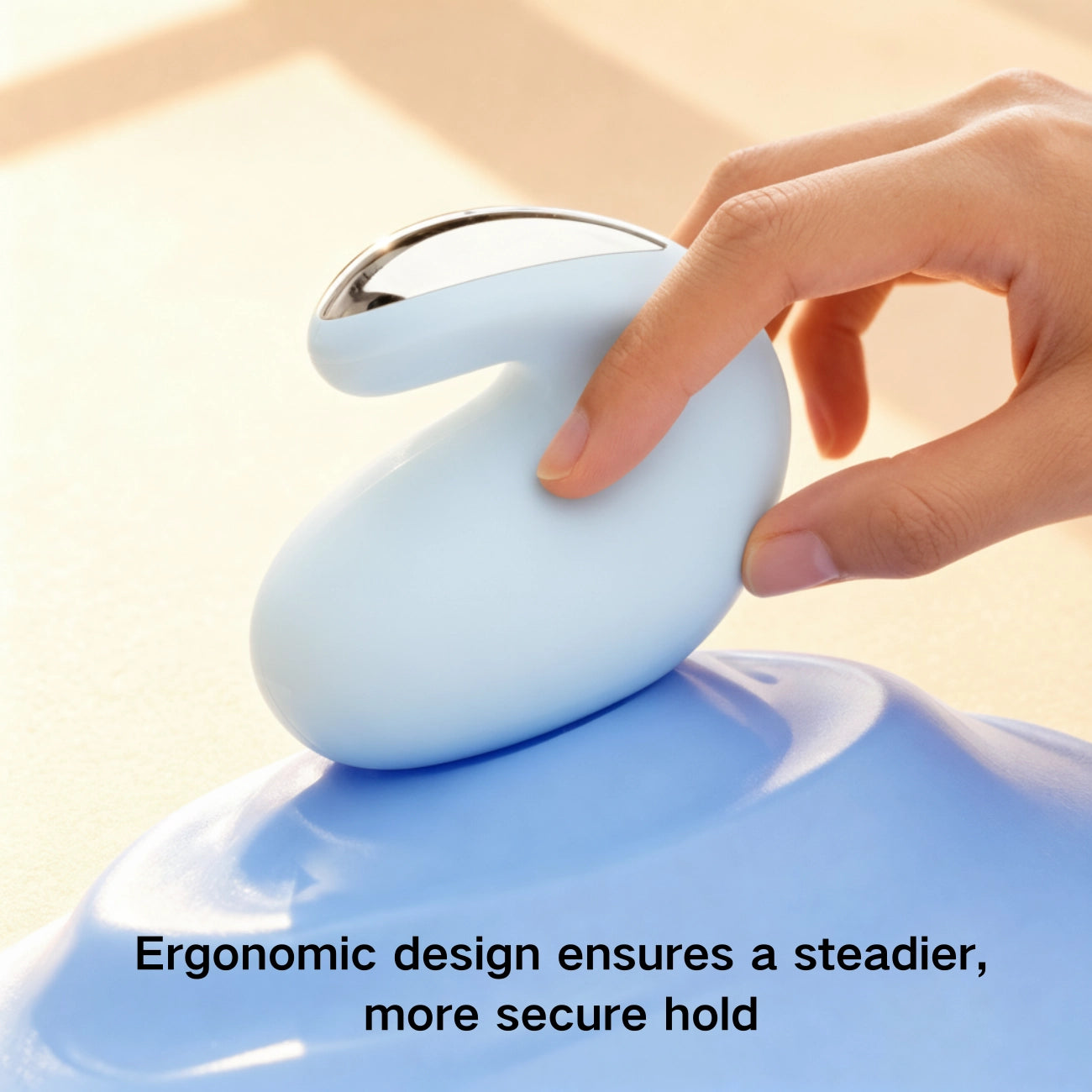 A hand gently pinching the pastel device to show its ergonomic clamp-style design and comfortable grip