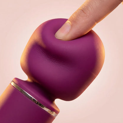 Soft massage head being gently pressed or bent to show its flexibility and cushioning feel.