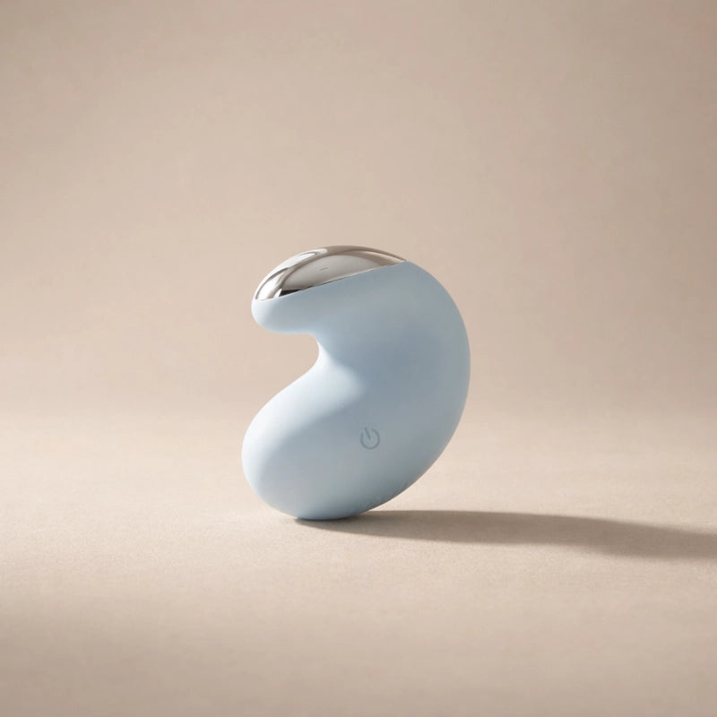 Blue massager with a silver top on a beige background