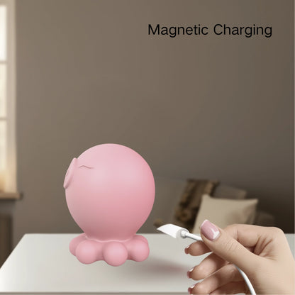 Close-up of hand connecting magnetic USB charger to pink octopus vibrator, rechargeable sexual wellness tool with eco-friendly design and modern aesthetics.