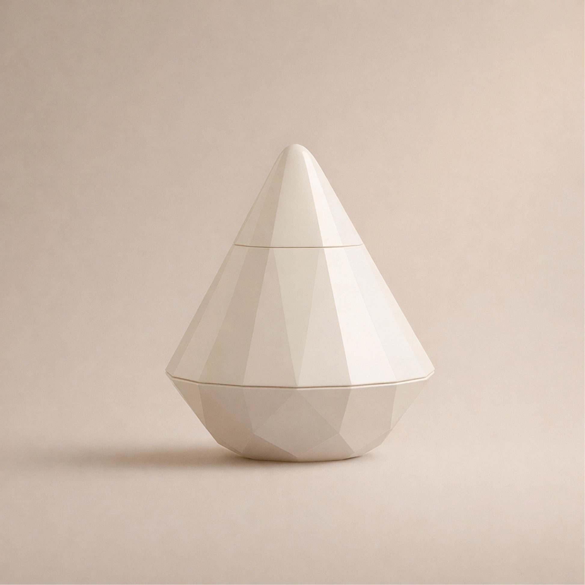 High-end product image showing a pearl-white diamond-shaped wellness device with a hygienic 