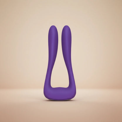 Elegant rose-purple silicone wellness device floating in soft diffused studio light against a white-to-blush gradient background.
