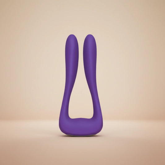 Elegant rose-purple silicone wellness device floating in soft diffused studio light against a white-to-blush gradient background.
