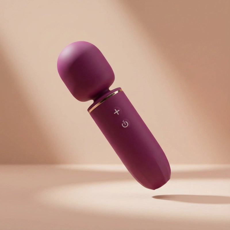 Microphone-shaped full-body massager with a soft silicone head, wide-surface vibration, and minimalist feminine design.