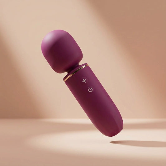 Microphone-shaped full-body massager with a soft silicone head, wide-surface vibration, and minimalist feminine design.