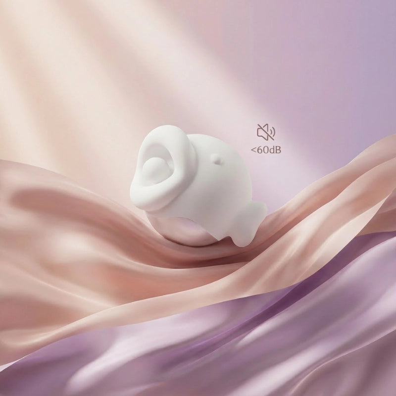 massager resting on soft fabric with <60dB icon, representing discreet quiet performance
