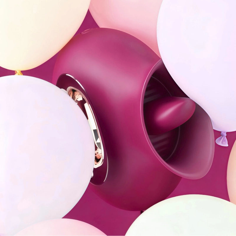 Burgundy and gold earring with balloons in the background