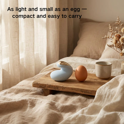 The compact device placed beside a light-colored egg to show its weight of under 48 g.