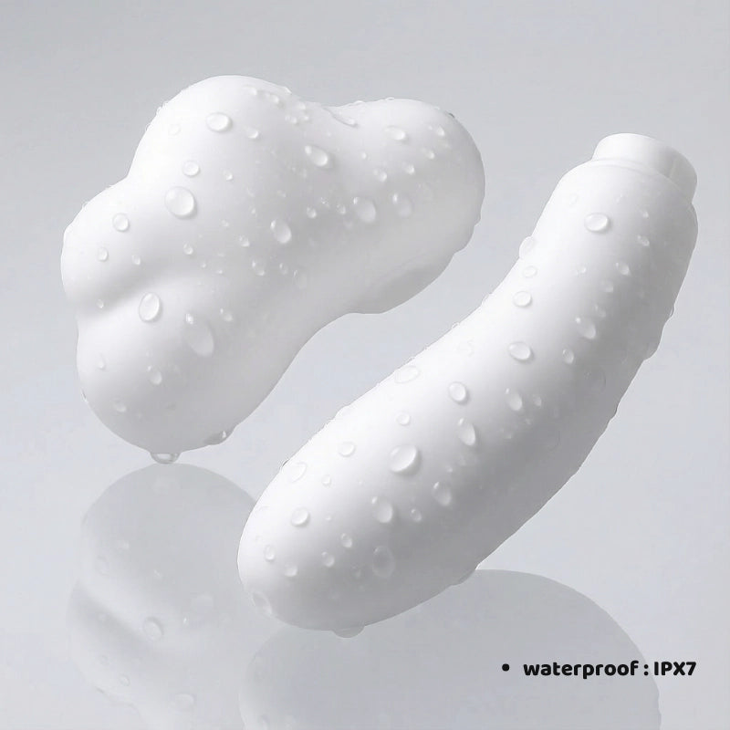 Lifestyle image showing the two modular components of the mushroom-cloud-shaped pleasure product separated and resting on a clean surface. The text "WATERPROOF: IPX7" is clearly visible, highlighting that both the suction stimulator and the vibrating base are fully submersible for easy cleaning and versatile use in the bath or shower.