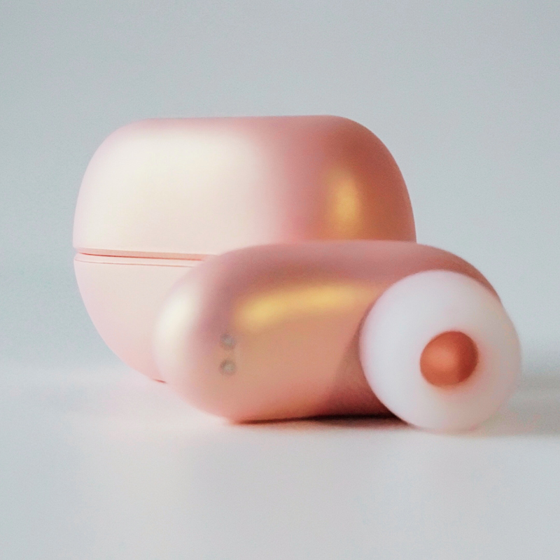 Close-up on the smooth, pink finish and cute design of the headphone-shaped device.