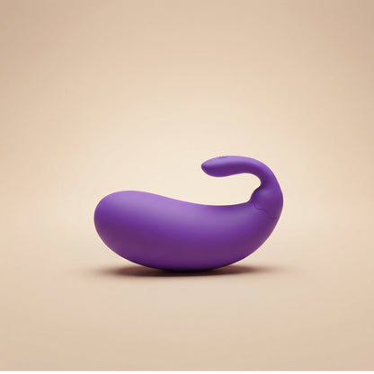 Purple toy with a curved design on a beige background