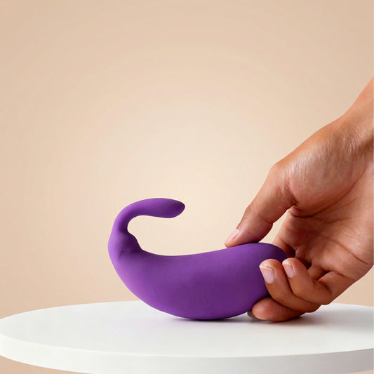 Front view of the playful purple mini eggplant vibrator held comfortably in a hand, showcasing its compact and discreet size for personal use.
